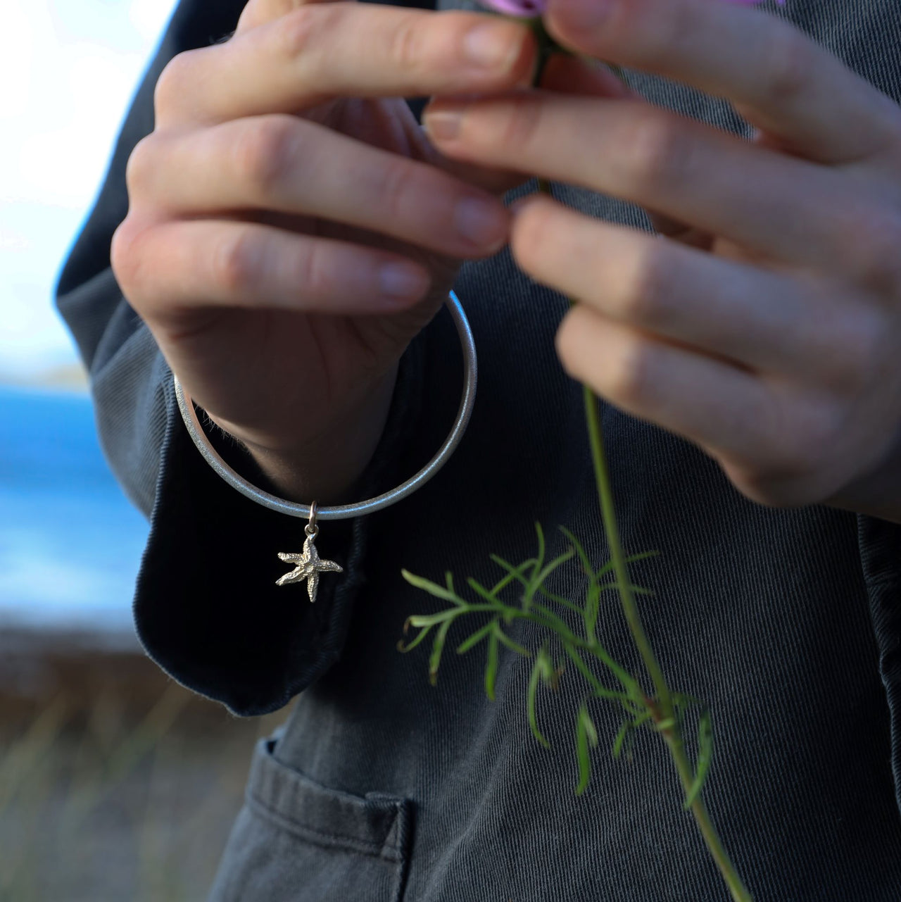 Silver bangle with solid 9ct gold starfish