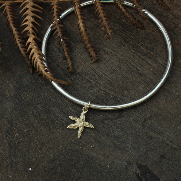 Silver bangle with solid 9ct gold starfish