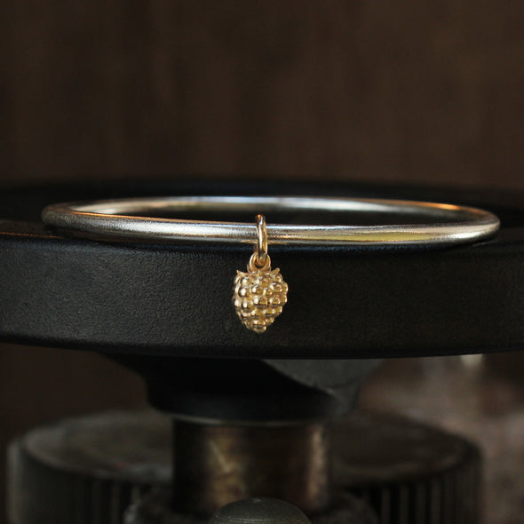 Small solid 9ct gold blackberry on silver bangle